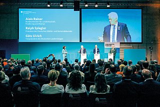 Foto von Redenern am Pult mit Publikum